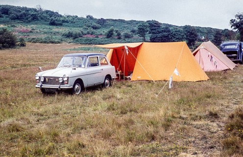 Austin A40 Farina caravan site with tents, Pembrokeshire, West Wales, UK around 1960