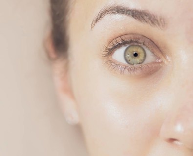 Close-up of a human eye with clear details and neutral background