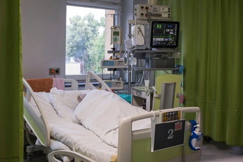 LUBIN, POLAND - JUNE 16, 2025: a patient in a hospital bed and the equipment next to it in the
