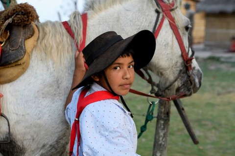 Young Gaucho with his horse at Puesto Mingo, portrait, Esteros del Iberá, at Concepción del