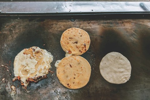 Top view of traditional pupusas on grill. Traditional grilled cheese pupusas