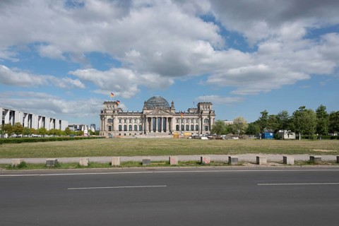 The Reichstag in Berlin under a cloudy sky, seen from a street, Berlin, Germany