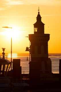 Pingelturm, historic lighthouse in the harbour, picturesque, golden, beautiful sunset, silhouette
