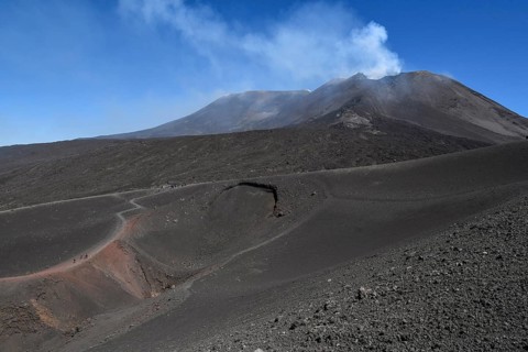 Hikers in the crater landscape of the volcano Etna, summit region, province of Catania, Sicily,