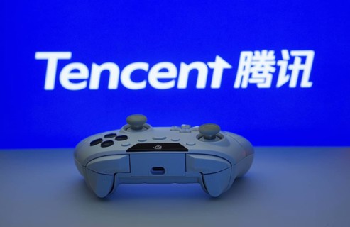 Dhaka, Bangladesh- 12 June 2025: Game controller in front of Tencent logo on a blue background
