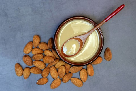 White almond cream in small bowls, almond butter