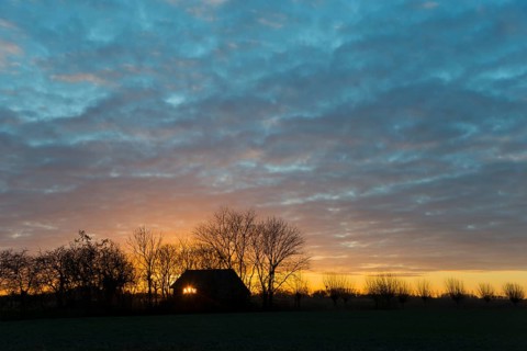 Sunset, sky burning, evening sun shining through a window of a house, house on the Dijkweg,