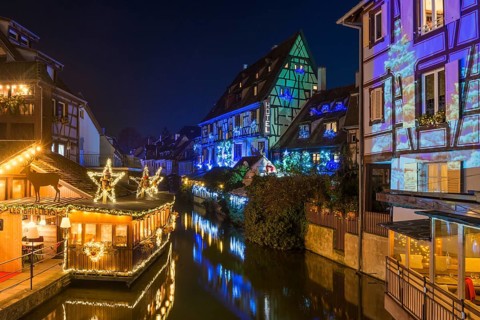 Colourfully illuminated and Christmassy decorated half-timbered houses, old town, blue hour,