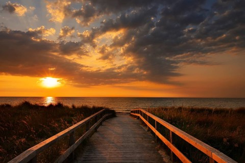 Wooden walkway through the dunes on the Baltic Sea at sunrise, Dahme, Ostholstein, Germany