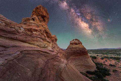 A breathtaking view of the Milky Way illuminating the night sky over unique desert rock formations