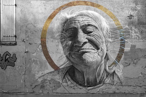 Painting of an old woman on an old house facade, black and white, Paris, France