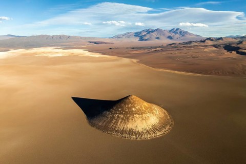 Top view, the Cono de Arita rises starkly against the flat expanse of Argentina's Salta desert.