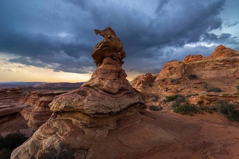 A striking sandstone formation stands under a moody sky at Coyote Buttes in the Paria