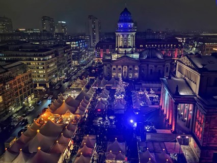 Colourful lighting over festive Christmas market tents on the Gendarmenmarkt