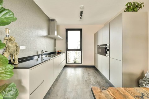 A contemporary kitchen showcasing elegant cabinetry, sleek countertops, and modern appliances,