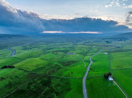 Forest in Teesdale over River Tees from a drone, North Pennines AONB, County Durham, England,