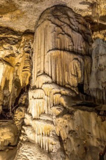 Majestic stalagmite formation rising from the cave floor, showcasing nature's artistry in postojna