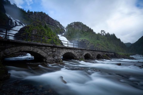 Summer day visiting Låtefossen falls near Odda, flowing water and green valley, Vestland, Norway