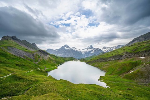 View of mountain landscape with Bachalpsee mountain lake, Finsteraarhorn peaks and Schreckhorn with
