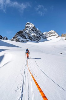 Ski tourer with rope, rope team on the Vadret da Porchabella glacier on the ascent to the summit of