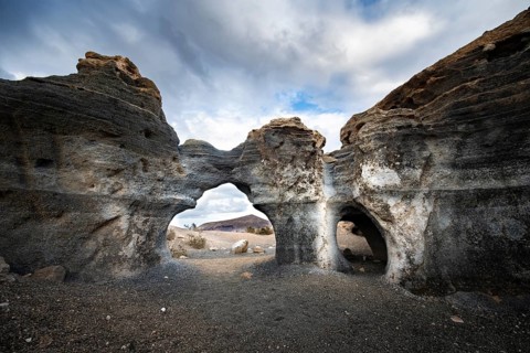Eroded rock formations, volcanic landscape with dramatic cloudy skies, Ciudad Estratificada or Los