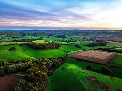 Sunset of Devon Farms and Fields over Berry Pomeroy from a drone, Totnes, England, United Kingdom