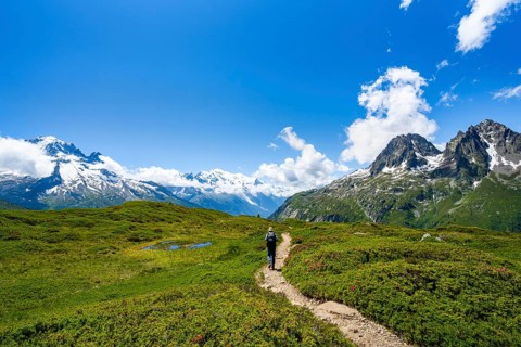 Mountaineers on hiking trail, mountain panorama with glaciated mountain peaks, Aiguille du Midi and