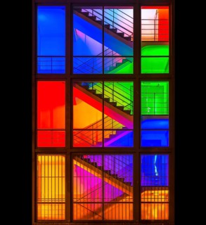 View through the windows of a brightly lit staircase. Frankfurter Mainova AG building, city center,