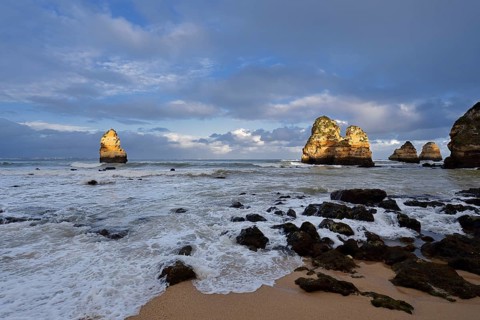 Rock formations on the coast in the evening light, Praia do Camilo, Lagos, Algarve, Portugal
