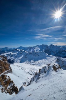 View of a ski resort piste and Dolomites mountains in Italy from Passo Pordoi pass. Arabba, Italy
