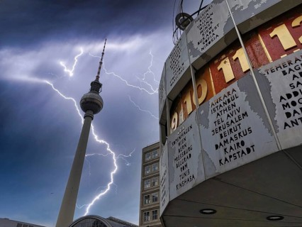 Lightning and dark clouds, work, over the Berlin World Clock and the Berlin TV Tower,