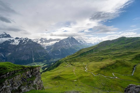 View of the mountain landscape of Grindelwald First, snow-capped mountain peaks Eiger and