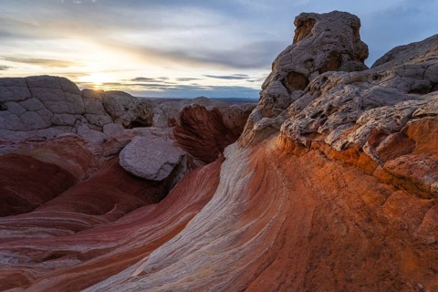 Enchanting view of a vibrant sunset casting warm hues over the twisted rock formations and colorful
