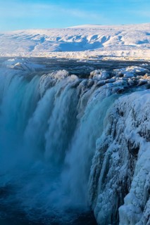 Godafoss waterfall in first morning sun, snow-covered landscape, Northern Iceland Eyestra, Iceland