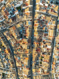 Streets and rooftops in the White Town of Olvera. Aerial view. Drone shot. Cádiz province,