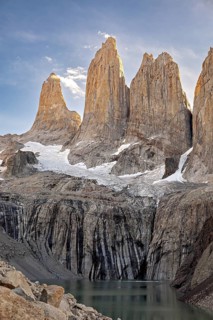 Impressive rocky towers above a clear mountain lake in the evening light, The rock towers of Torres