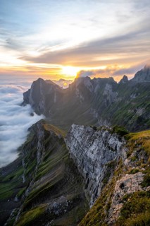View over Säntis mountains into the valley of Meglisalp at sunrise, high fog in the valley, Säntis,