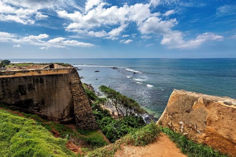 Fortress on a rocky coast with blue sea and cloudy sky, The fortress of Galle in Sri Lanka