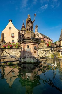 Fountain Fontaine de Saint-Léon and St Leo's Chapel in Eguisheim, Alsace, France