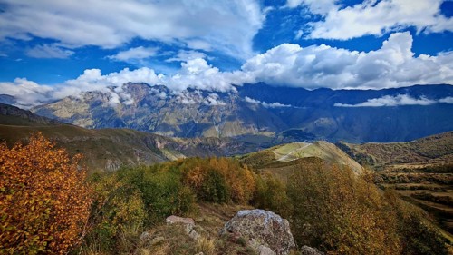 Autumn landscape with colorful foliage against a mountain backdrop, Stepantsminda, Caucasus,