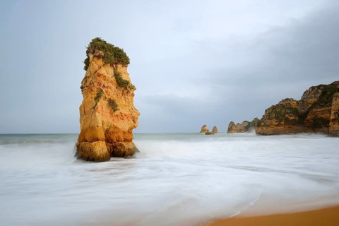Rocks on the coast in the surf, Praia Dona Ana, Lagos, Algarve, Portugal