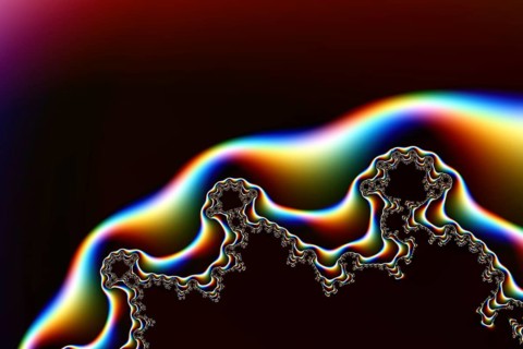 Vibrant and intricate fractal design featuring smooth gradient transitions on a dark background,