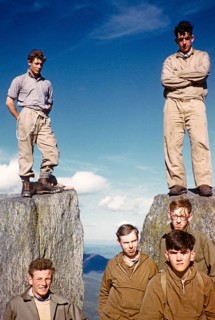 Group of young male climbers standing high on a rock, probably North Wales, United Kingdom, c. 1958