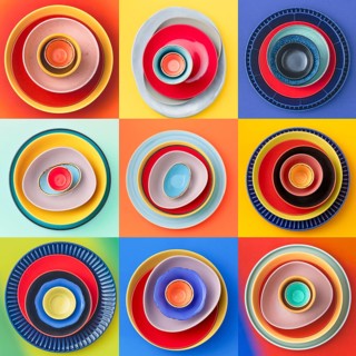 A collection of colorful ceramic dishes arranged in three by three grid. Each set is placed on a