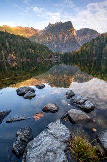 Mountain peaks of the Ötztal Alps reflected in Lake Piburger See, in autumn, near Ötz in Ötztal,