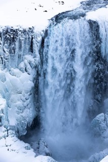Dettifoss waterfall with icy and snow-covered rock face, Northern Iceland Eyestra, Iceland