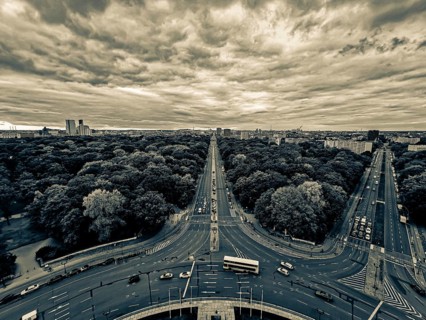 A dramatic black and white image of Berlin with an impressive avenue and cloudy sky, view from the