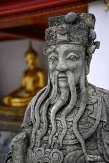 Stone statue of a Chinese warrior, guardian, Wat Pho, Temple of the Reclining Buddha, Bangkok,
