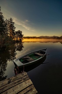 Boats in the autumnal Schmutter Weiher in the Allgäu near the municipalities of Halblech,