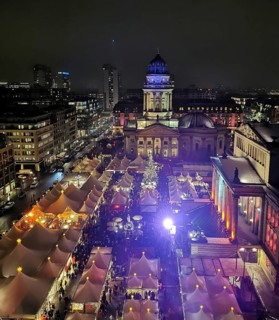 Aerial view of a busy Christmas market on the Gendarmenmarkt at night, Berlin
